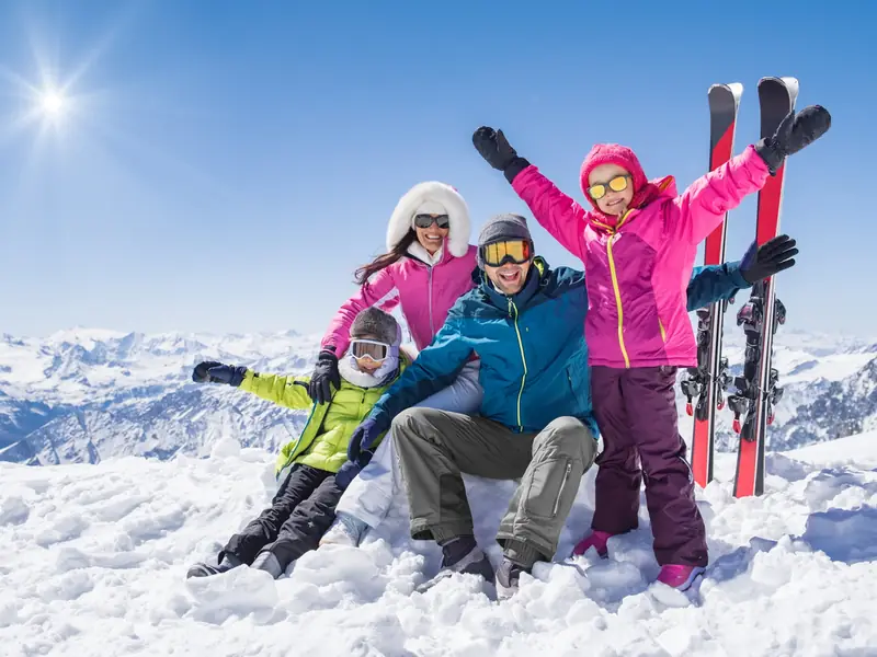 A family with skis in the snow